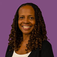 RealOptions Clinic - Education Staff. African american woman smiling in a professional portrait headshot at RealOptions Medical Clinic.