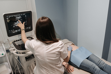 Pregnant patient receiving an ultrasound examination from a healthcare provider